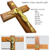 A wooden Catholic cross with a gold crucifix figure mounted on the wall.