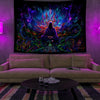A dark tapestry featuring a glowing figure surrounded by vibrant purple, blue, and green psychedelic light.