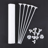 White macaron balloon sticks with holder cups arranged diagonally on a dark background