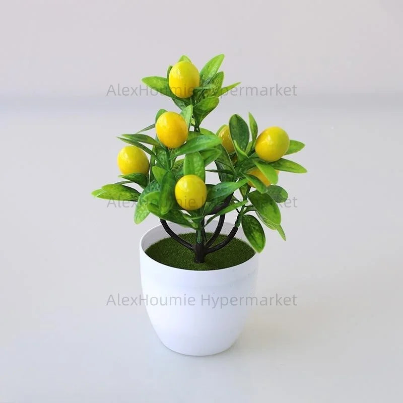 Artificial lemon tree bonsai with yellow fruit growing in a white pot