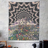 Wall tapestry featuring a psychedelic eye radiating light over a mountain landscape covered in colorful flowers.