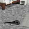 Roll of realistic wood grain floor stickers laid out on a concrete floor.