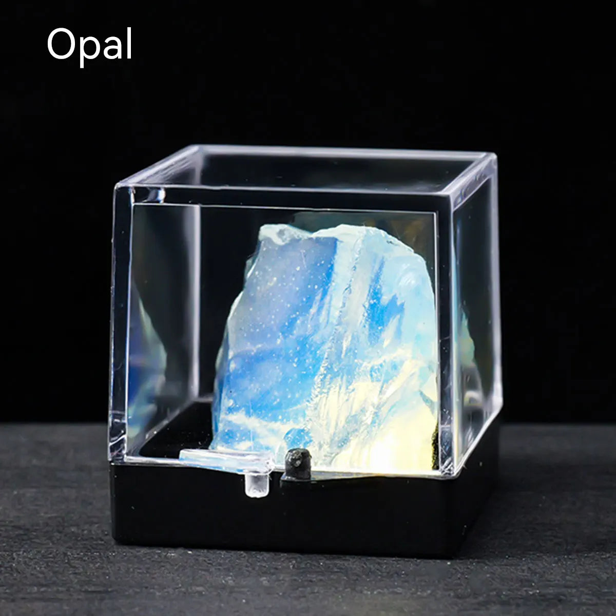 A clear display box shows a rough, translucent blue and white opal crystal specimen.