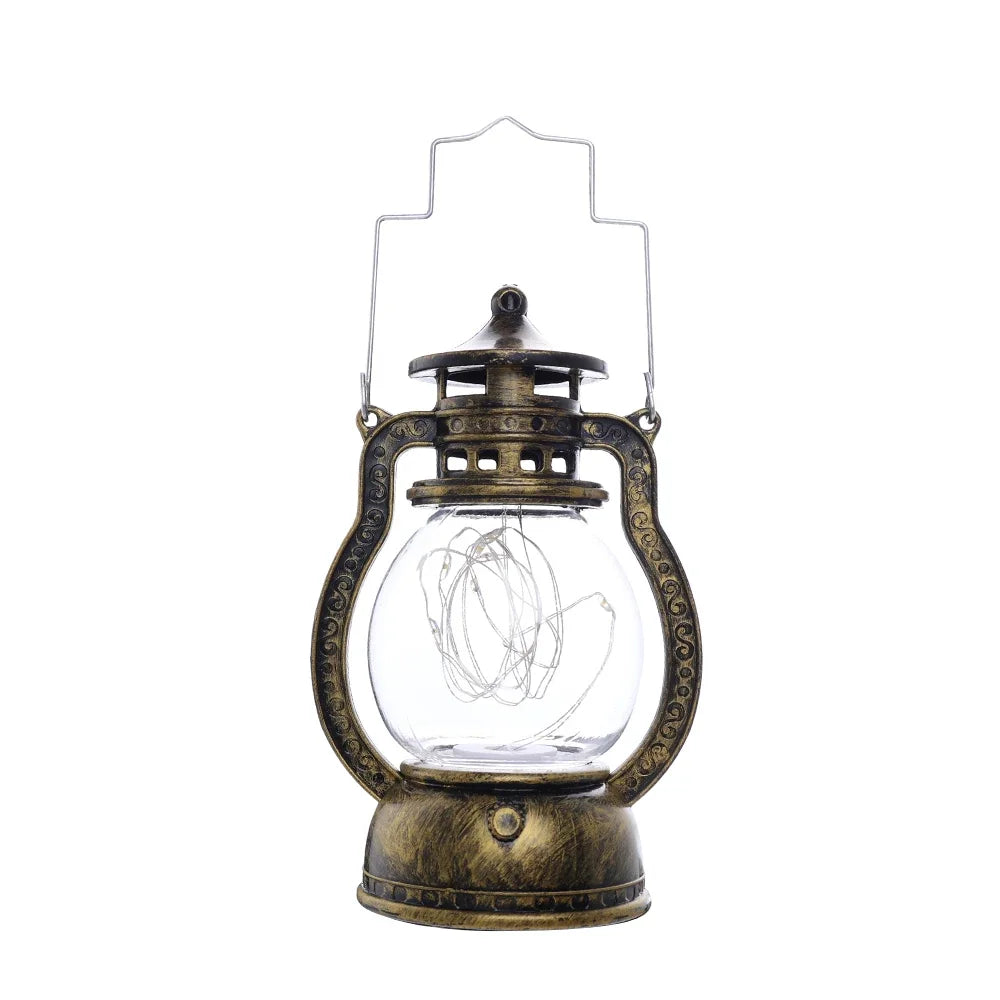 A brass-colored LED lantern night light with a clear glass globe and decorative metalwork.