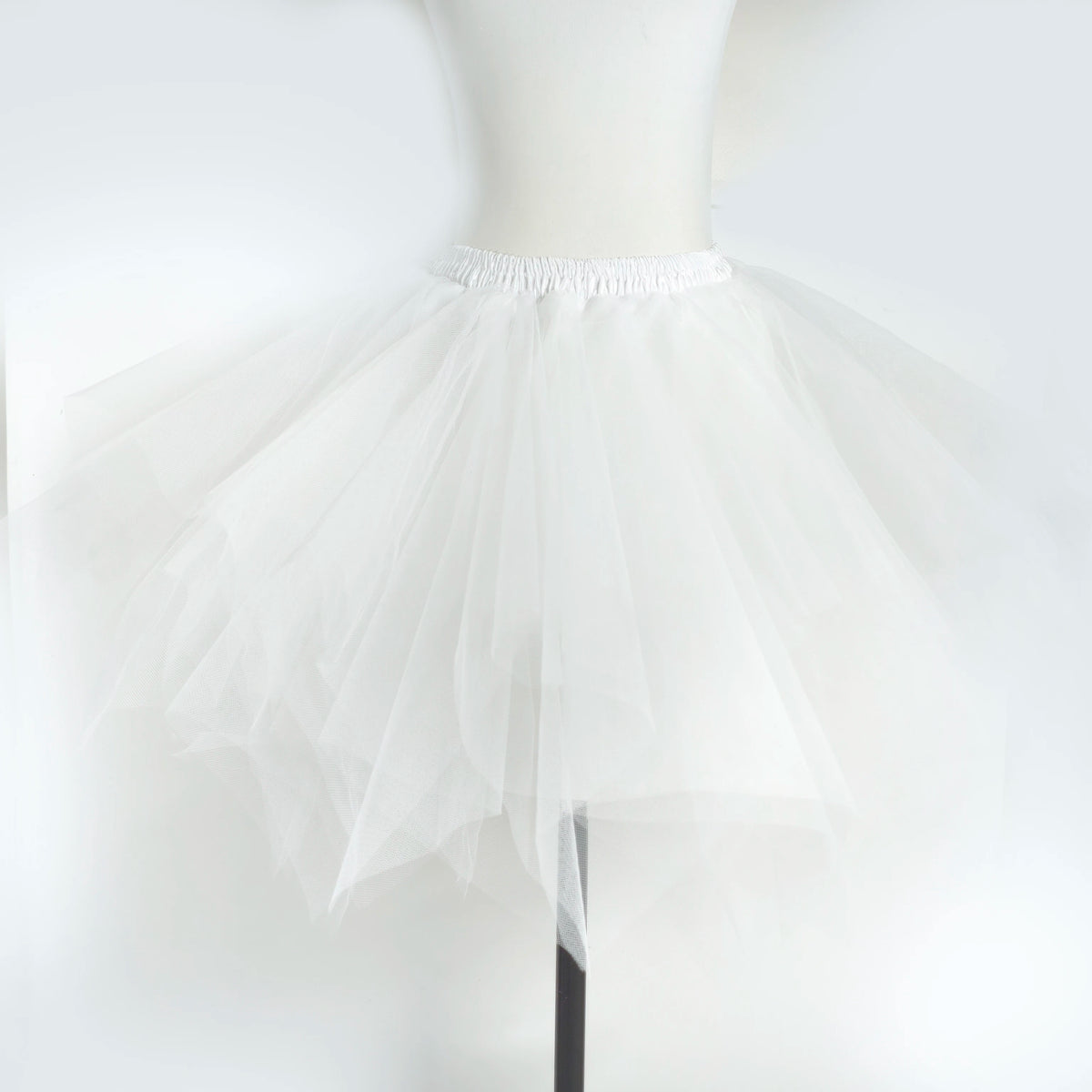 White adult tulle tutu skirt displayed on a mannequin.