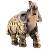 A bronze elephant statue decorated with gold accents, representing wealth and good fortune.