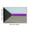 A lapel pin featuring a geometric design with black, purple, and light blue sections.