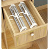 A wooden drawer organizer holding two stainless steel foldable multi-layer pants hangers.