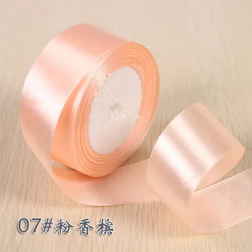 Roll of pink silk satin ribbon for gift wrapping and craft projects