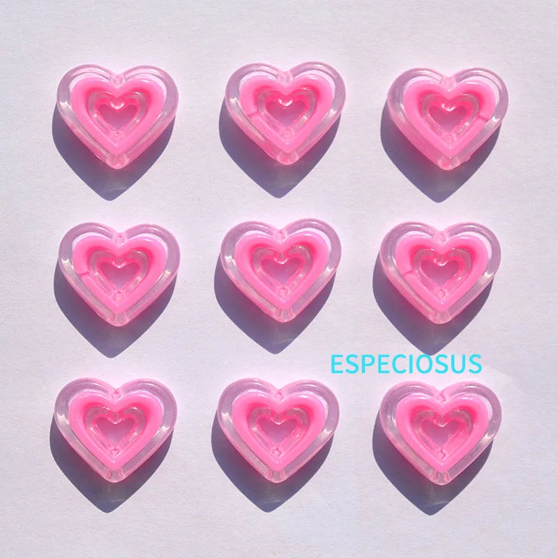 A set of pink heart-shaped acrylic charms arranged in a grid on a white background.
