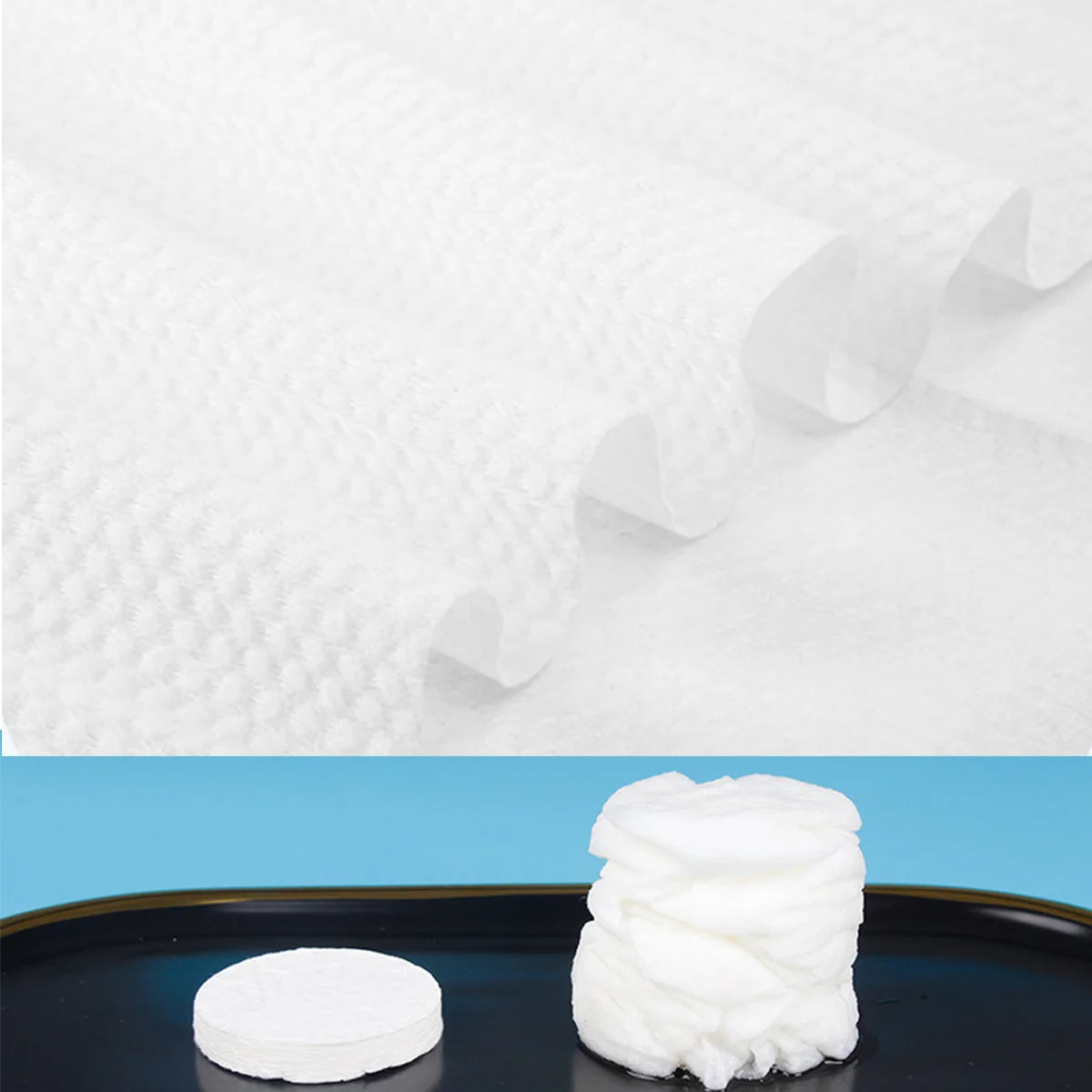 A stack of white compressed camping towels on a dark surface.