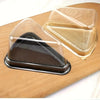 Clear disposable plastic containers for cake slices, including a dark brown and a golden colored one.