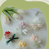A collection of dried and fresh tulips arranged in various colors and wrapped with sheer tissue paper for an aromatherapy can