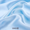 Close-up of light blue satin fabric draped and folded to show texture and sheen.