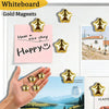 A hand holds gold star fridge magnets against a white board background.