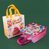 A set of reusable happy birthday gift bags in pink and white with yellow handles, featuring colorful balloons and a cake desi