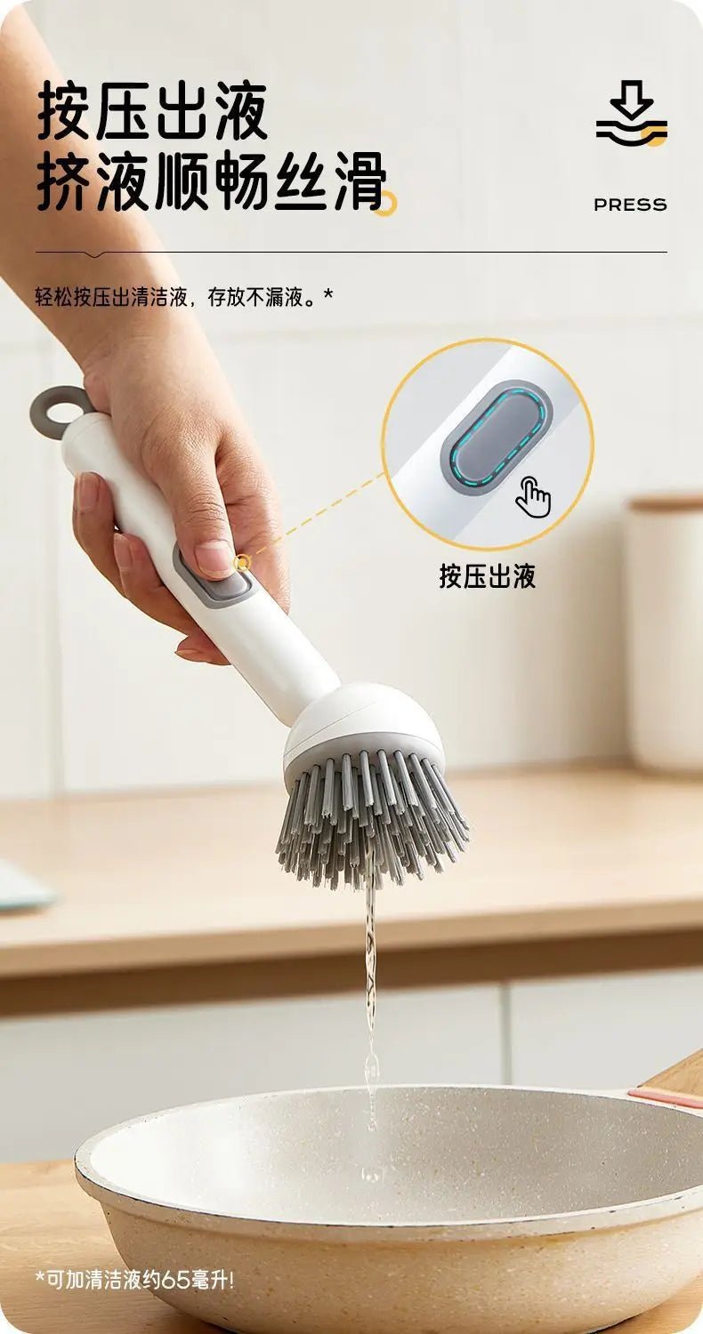 A hand is using an adjustable long-handled liquid washing brush to press and wash food residue from a bowl.