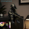 A dark green tactical sniper soldier figurine with a helmet and rifle is displayed on a shelf.