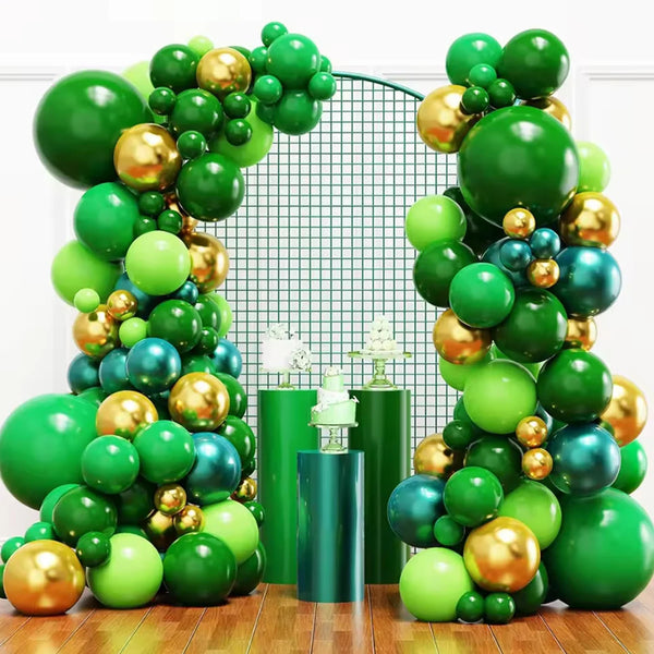 A large arrangement of green and gold latex balloons forming a backdrop for a celebration.