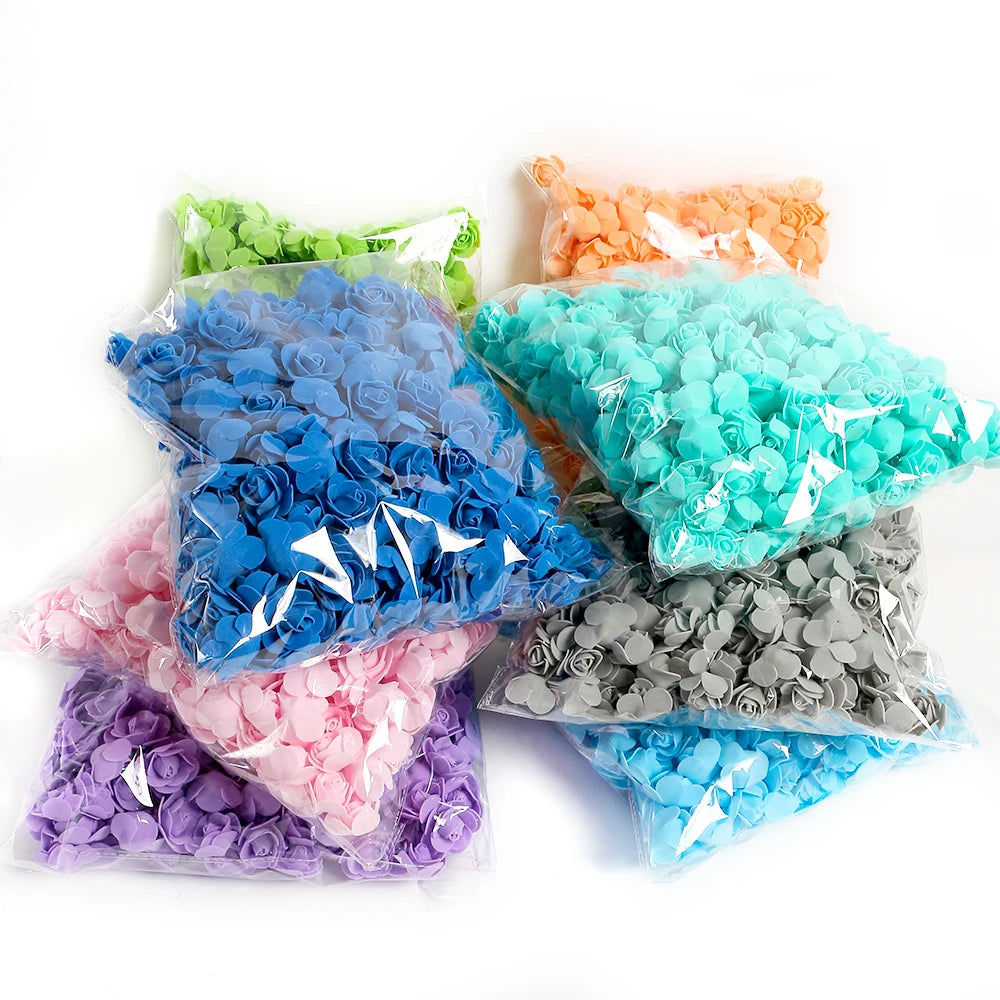 A collection of artificial foam rose flowers in various colors including blue, green, orange, pink, and gray.