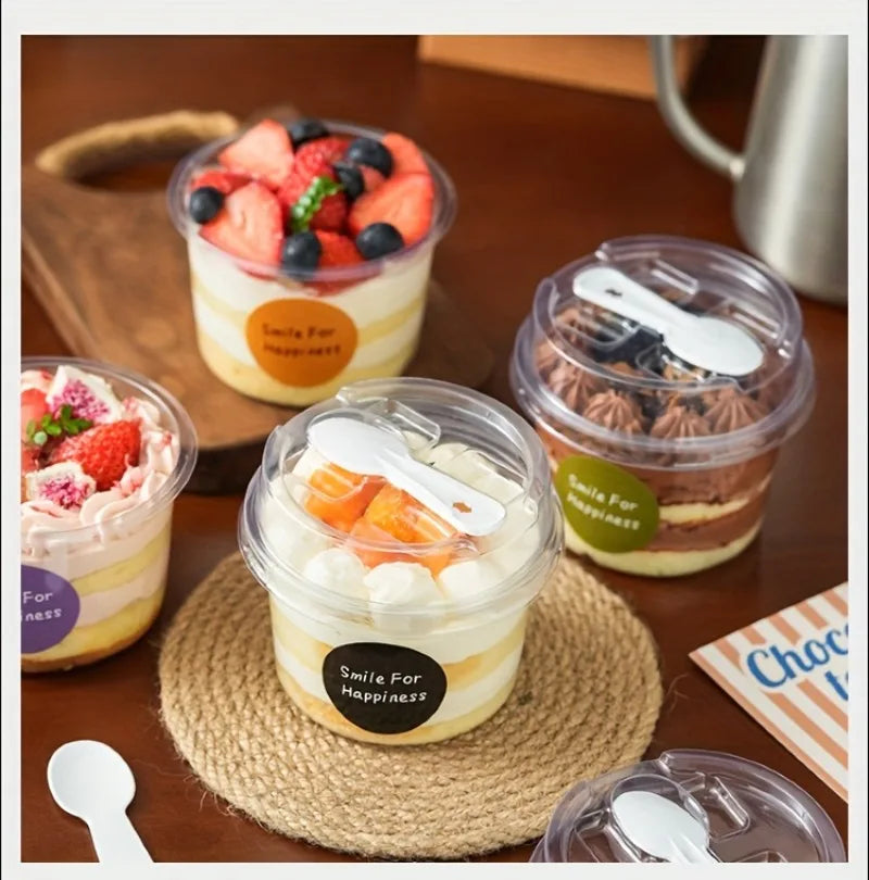 A collection of reusable pudding cups filled with layered desserts like fruit and cream, set on a wooden surface.