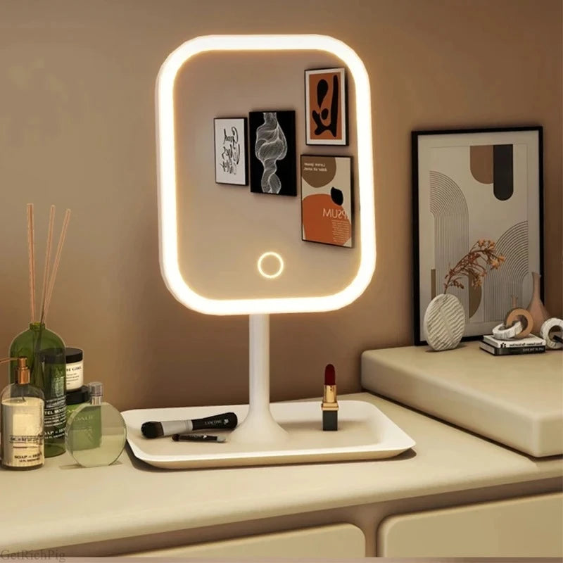 A modern white vanity mirror with a glowing LED frame displaying various makeup products.