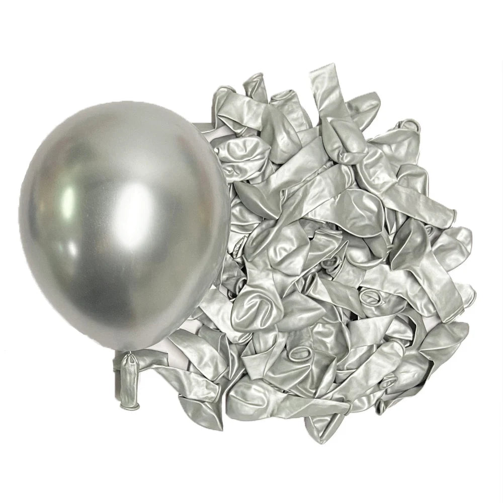 A single silver metallic latex balloon next to a pile of crumpled silver foil balloons.