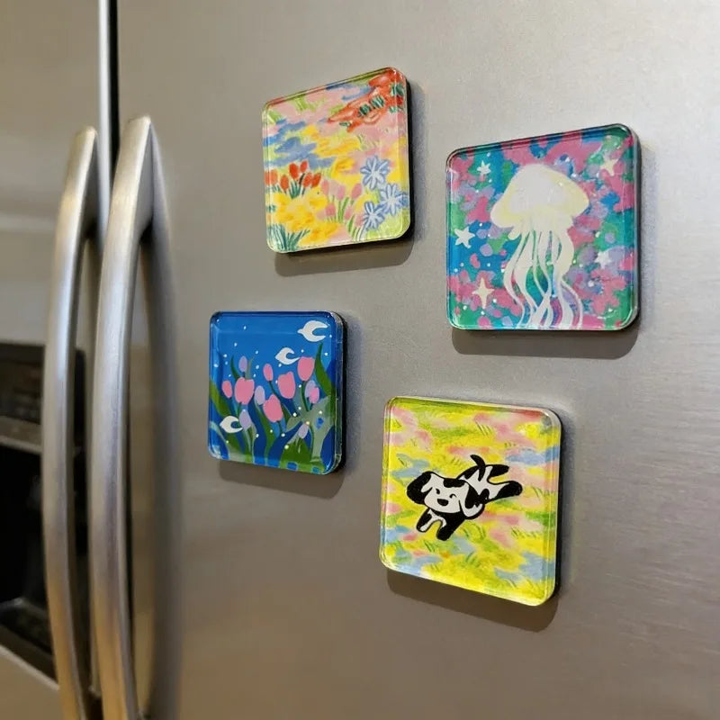 A collection of colorful acrylic fridge magnets featuring floral and whimsical designs.
