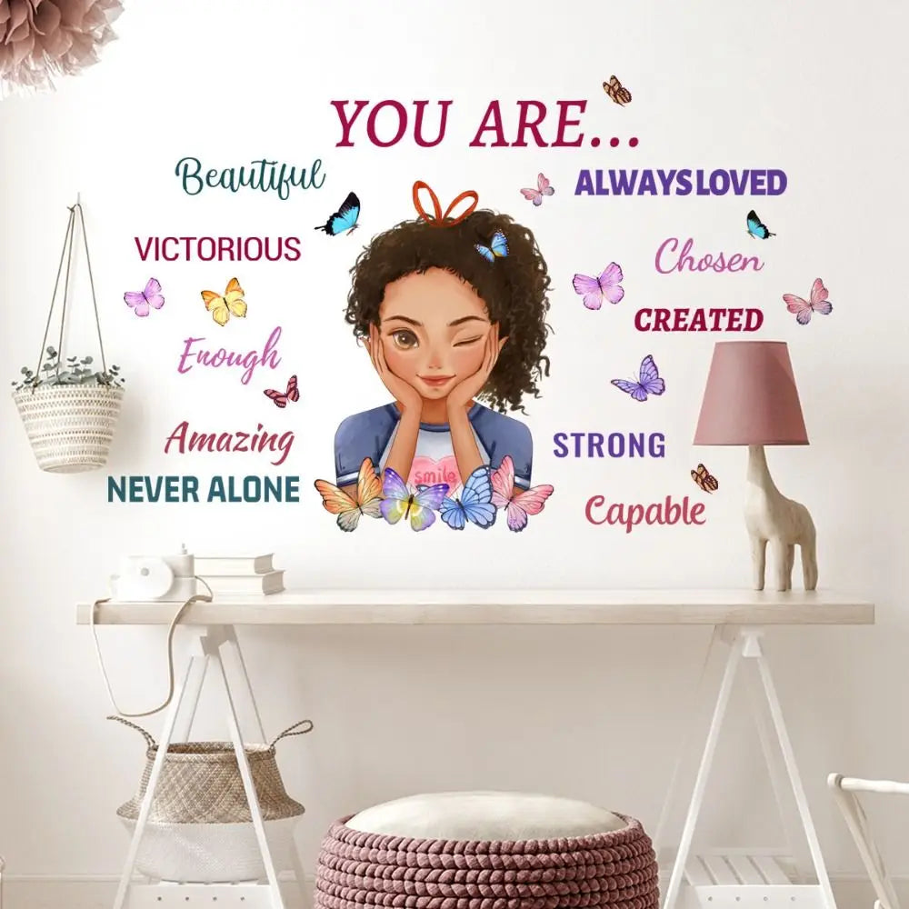A wall decal featuring inspirational words like Beautiful Victorious Loved Chosen Created Strong and Capable surrounded by bu