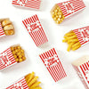 Various red and white striped boxes filled with popcorn and snacks are arranged on a white surface.