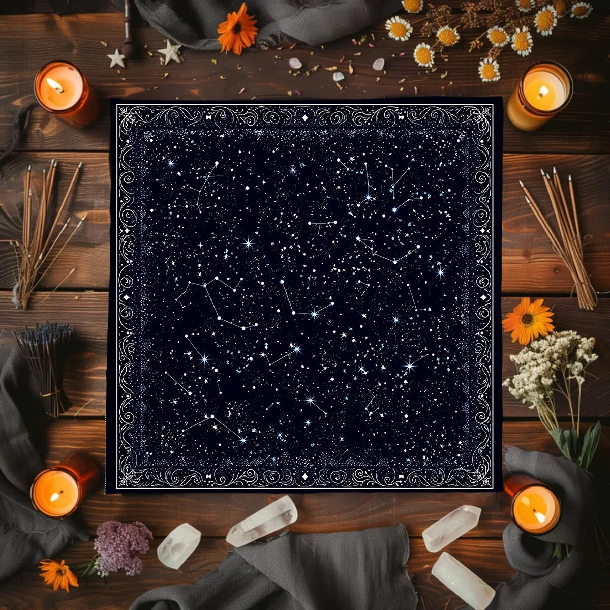 A dark velvet altar cloth featuring a starry night sky design surrounded by dried flowers and candles.