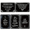 Three black metal tin signs featuring gothic and spooky Halloween themes for wall decor