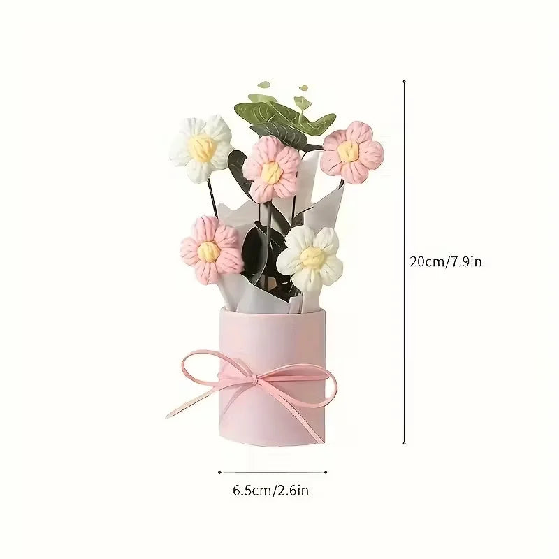 Handmade floral bouquet featuring pink and white flowers displayed in a pink cylindrical vase.