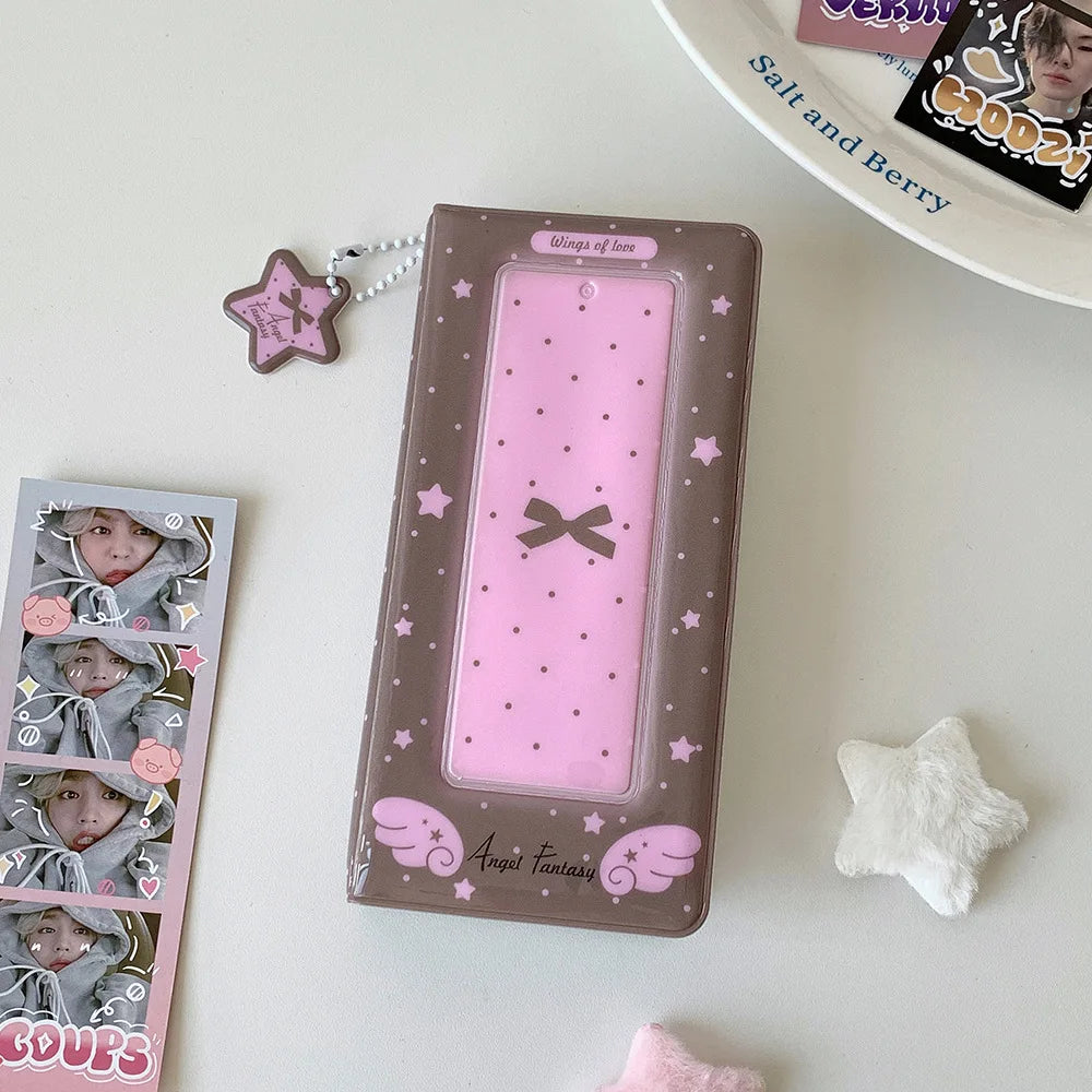 A brown photo booth album with pink accents and a bow is displayed on a white surface.