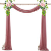A set of two dusty rose chiffon fabric panels used for draping a wedding arch.