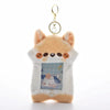 A fluffy orange cat keychain featuring a graphic of a girl playing, designed to hold photocards.