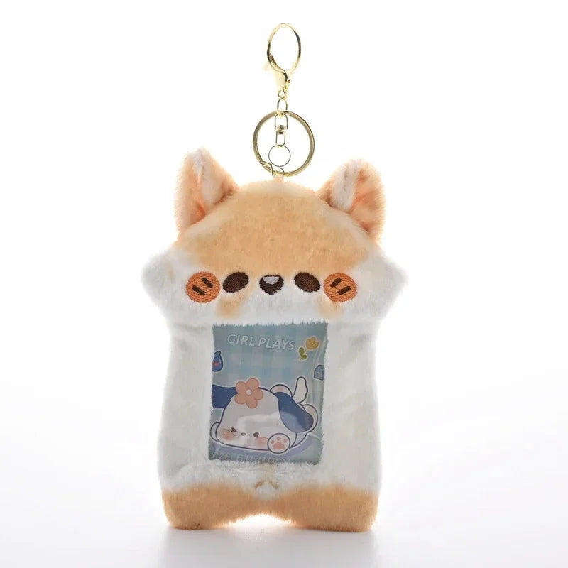 A fluffy orange cat keychain featuring a graphic of a girl playing, designed to hold photocards.