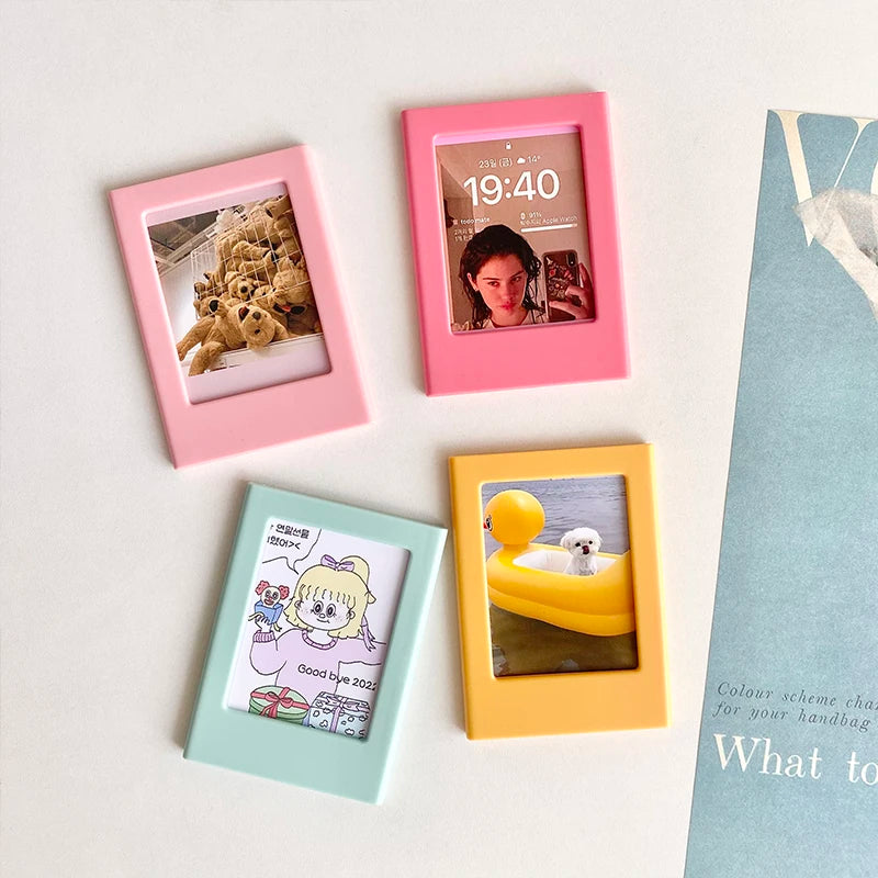 Four pink and yellow magnetic photo frames displaying different images and times on a white surface.