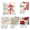A beige cushion cover featuring a red Christmas design with a bow and wreath pattern.