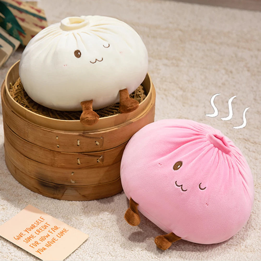 A white dumpling plush pillow rests in a wooden basket, with a pink version nearby.