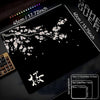 A black gaming mouse pad featuring a delicate white cherry blossom design and various size options.