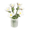 A bouquet of white and yellow flowers in a clear glass vase.