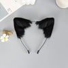 Black plush fox ears headband with thin black strings and a small white flower nearby