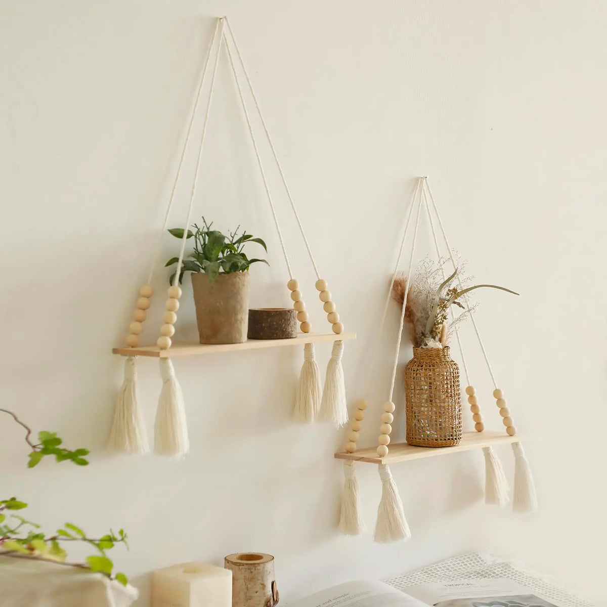 Macrame wood floating wall shelf with hanging rope displaying dried flowers and natural fibers.