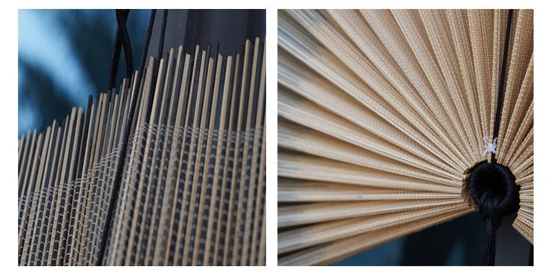 Close-up of a handwoven bamboo wall fan with light beige slats and a black tassel.