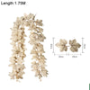 Long, light beige artificial maple leaf garland with small gold accents for home decor