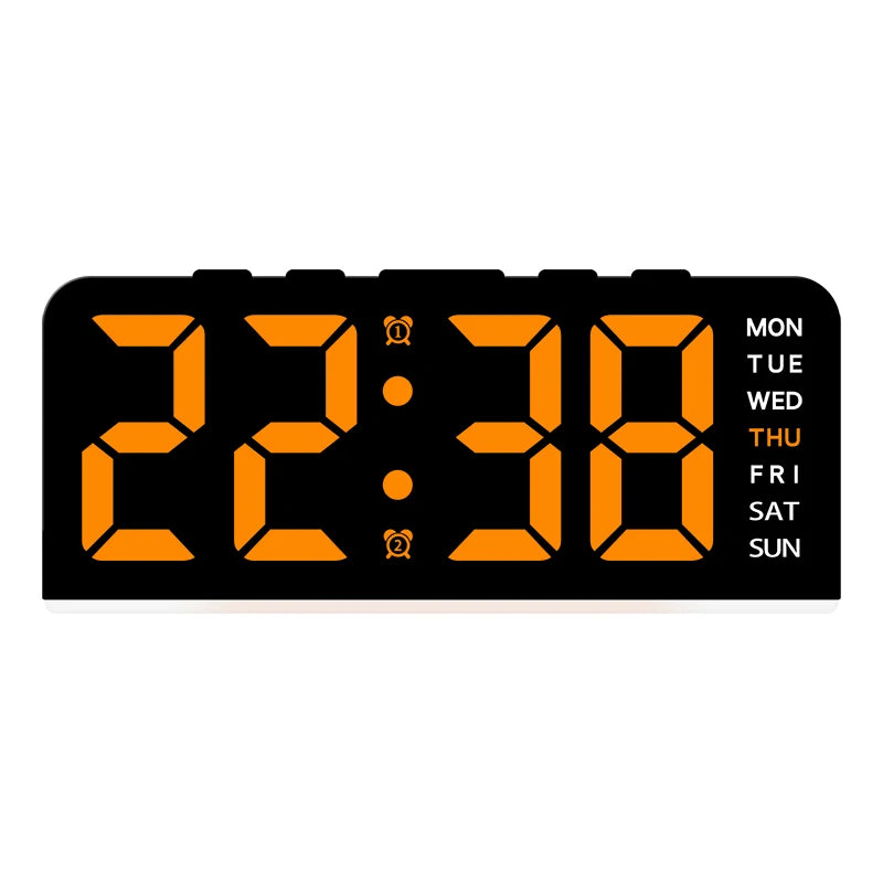 A black digital alarm clock displaying 22:38 with an orange backlight and day of the week indicator.