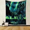 A dark tapestry wall hanging featuring a menacing alien head and claws in shades of teal and black.