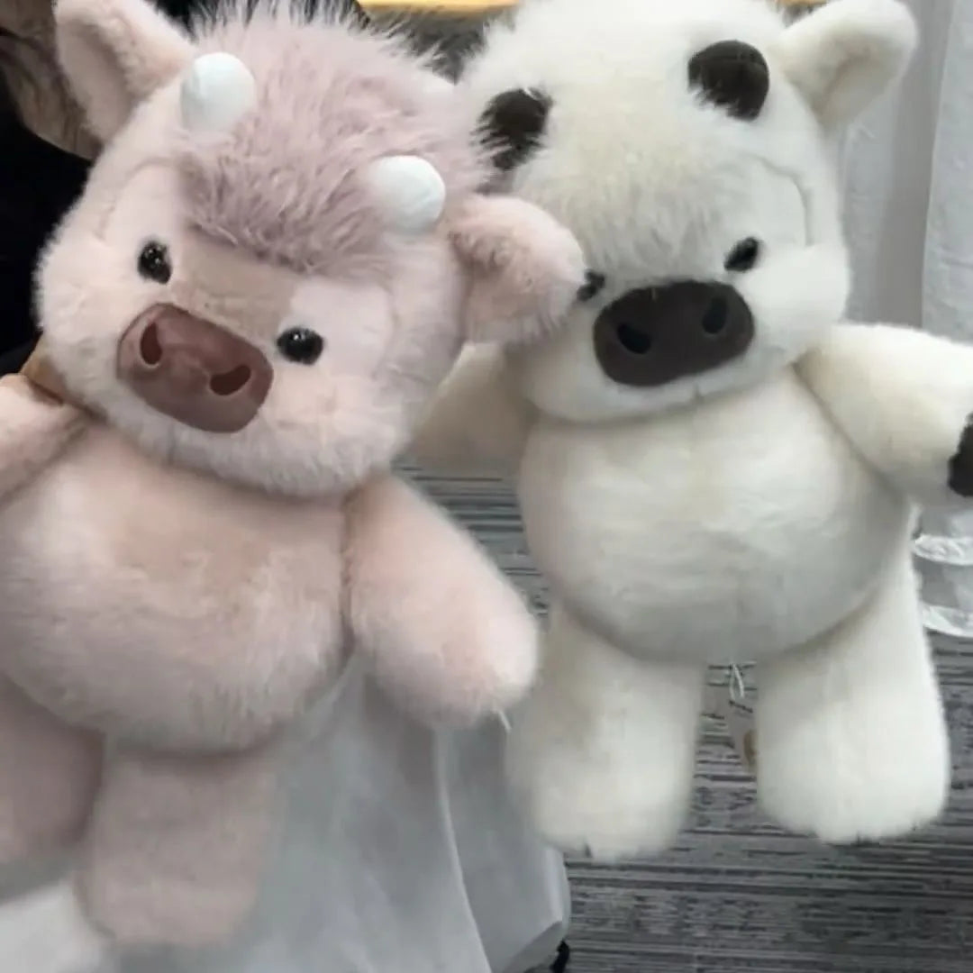 A fluffy pink and white plush toy featuring a baby llama or alpaca design.