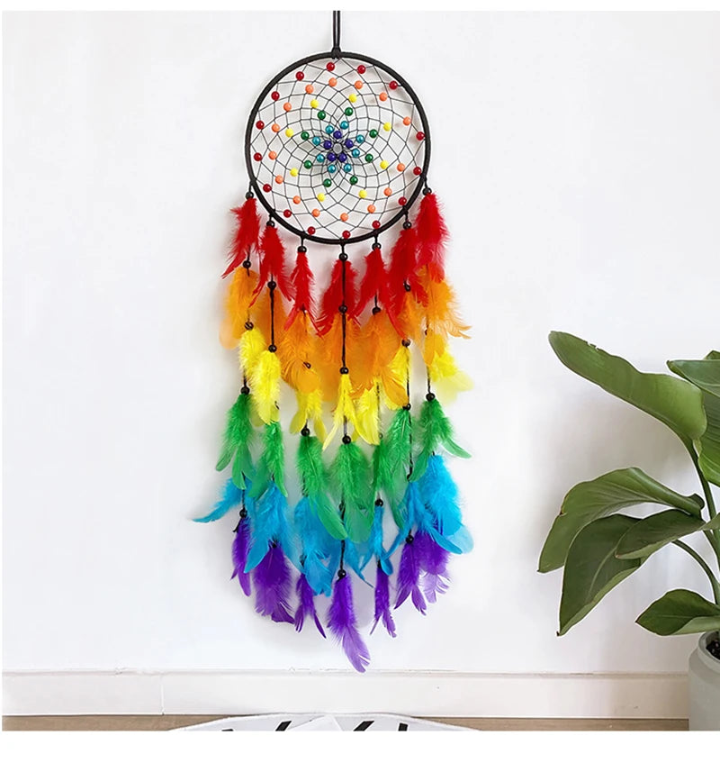 A decorative pendant featuring a black mesh dream catcher with colorful feathers in shades of orange, yellow, green, and blue